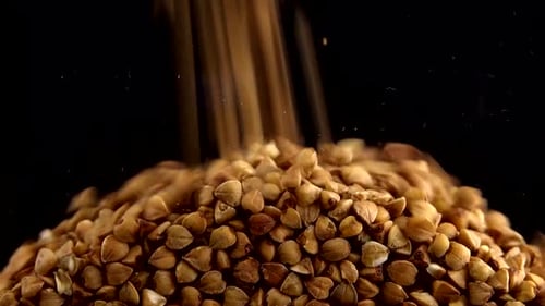 Buckwheat Grains Flowing and Piling Up Close