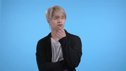 Man Thinking with Hand on Chin on Blue