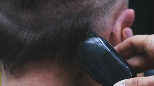 Hairstylist Shaves Black Hair on Client Head with Machine