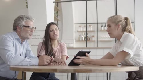 Confident Employees Discussing Project Together in Cafe