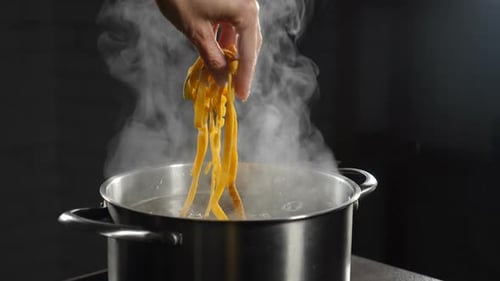 Adding Fresh Pasta to Boiling Water in Kitchen