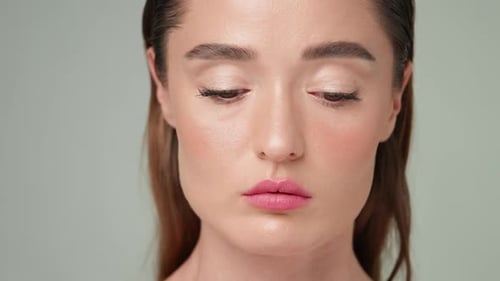 Close-up of Beautiful Young Woman with Professional Makeup