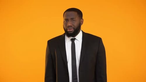 Upset African-American Office Worker Feeling Guilty, Failing to Perform Work