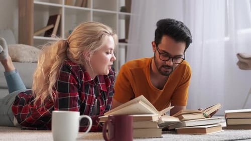 Young Couple Reading and Studying Together at Home