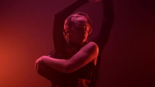 Graceful Couple Dancing in Dark Studio