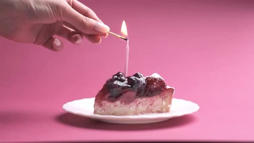 Lighting a Birthday Candle on a Slice of Cake