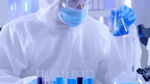 Scientist in Lab Examining Test Tube for Research