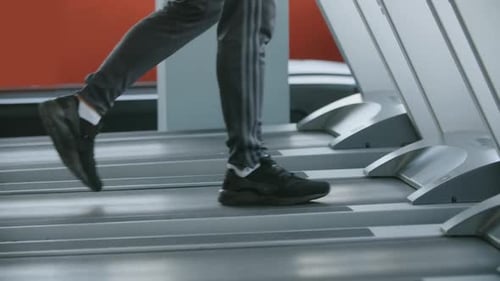 Sportsman Walking on a Treadmill in the Gym