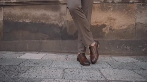 Stylish Man in Dress Shoes Poses Against Wall