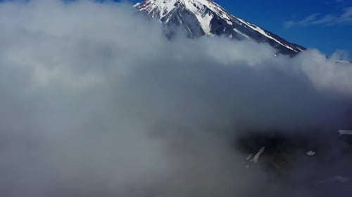 Flying Down Near Volcano Through Clouds