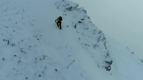 Mountain Climber on a Challenging Snowy Climb