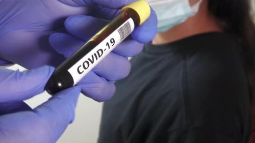 Doctor with blood test tube of Virus Coronavirus Covid-19