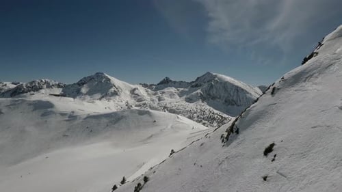 Skiing with a beautiful aerial view of the mountain cover with snow on a sunny day