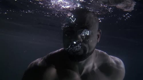 Man Swims Underwater and Blows Bubbles