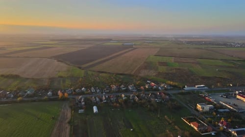 Aerial View of Village Roofs of a House in View of Green Countryside Field
