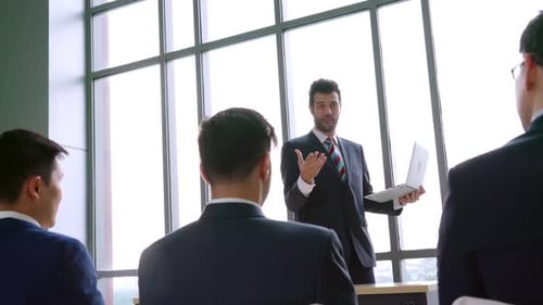 Business Team Presentation in Modern Workplace Setting