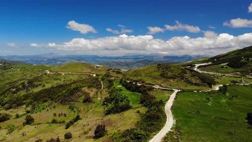 Scenic Rolling Green Hills and Winding Country Road
