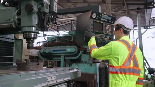 Smart Factory Worker Using Machine in Factory Workshop