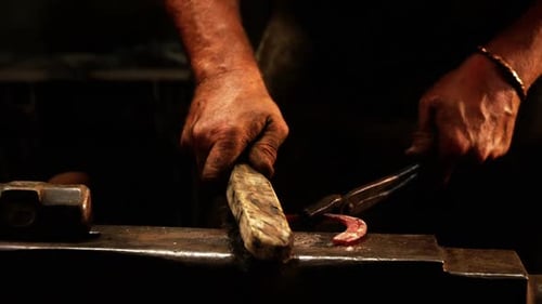 Blacksmith Shaping Red Hot Horseshoe With Hammer