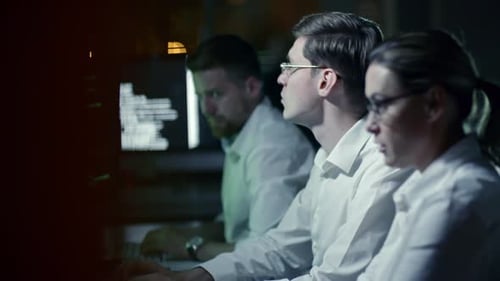 Team Working at Computers Late at Night