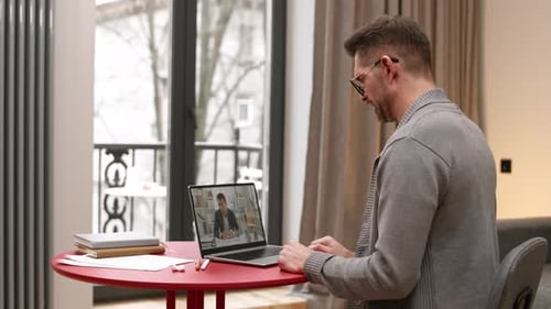 Adult Man on Video Call in Modern Home