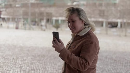 Woman Chatting on Mobile Phone in Urban Setting