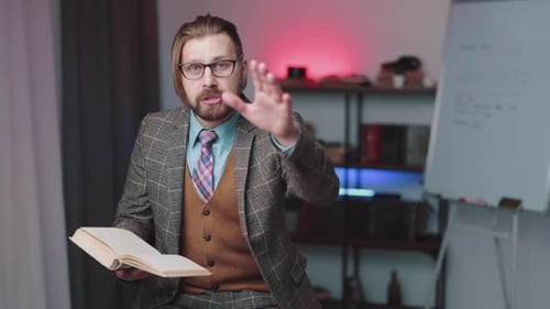 Man Explaining Book in Office Setting