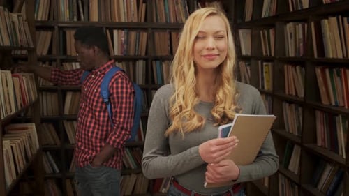 Students Studying in a Book Filled Library