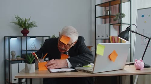 Tired Exhausted Senior Business Man Office Manager with Laptop Sticky Notes Sticks with Many Tasks