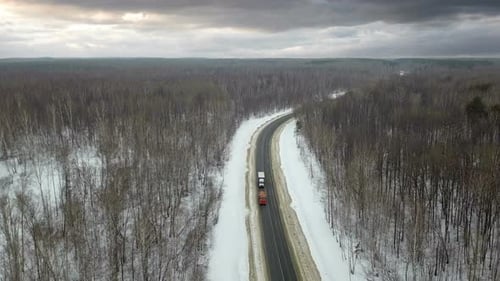 Trucks On Winter Road At Stormy Weather