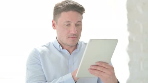 Portrait of Man using Tablet in Office