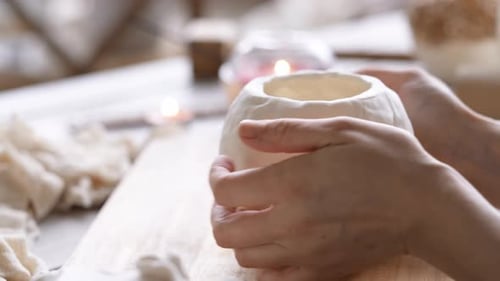 Hands Molding Clay to Create Ceramic Pot