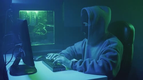 Anonymous Person Typing on Computer at Night