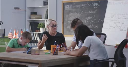 Teacher Instructing Students in Bright Classroom Setting