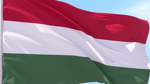 Waving Hungary Flag Against Blue Sky