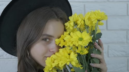 Portrait of a girl with yellow flowers.