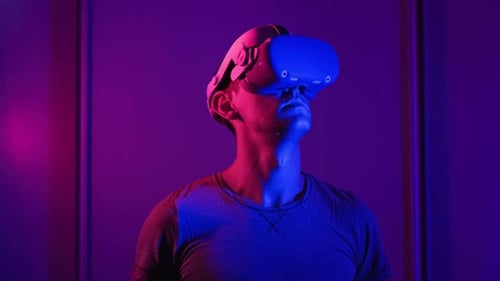 Man Wearing VR Headset in Futuristic Lighting