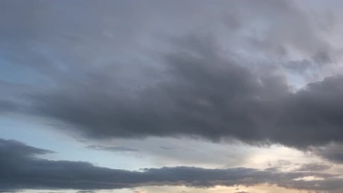 Dramatic Clouds Shifting in Orange Sunset Time-Lapse