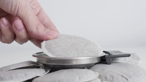 Coffee Pod Placed Into Filter Basket Close Up