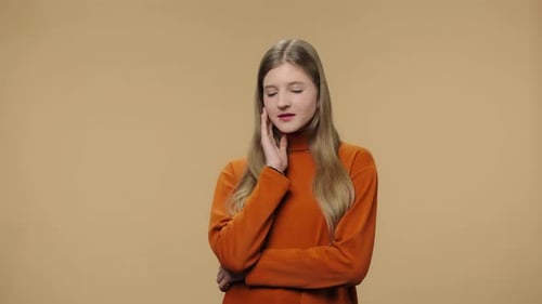 Young Woman Thinking and Touching Her Face