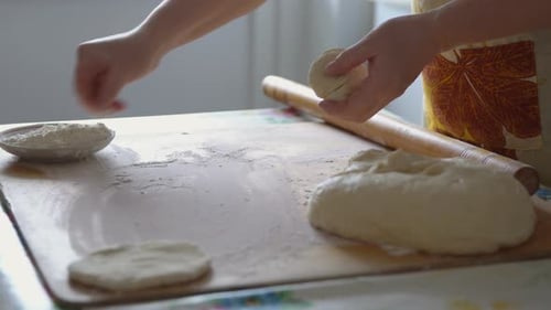 Woman Preparing Dough on Wooden Kitchen Table