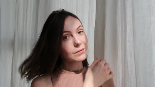 Smiling Woman Shakes Her Hair Back and Forth