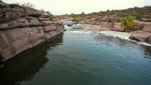 A Small Shining Stream Flows Among Smooth Wet and Dark Stones