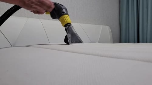 Close-up of Male Hands Cleaning the Mattress Professional Extraction Method
