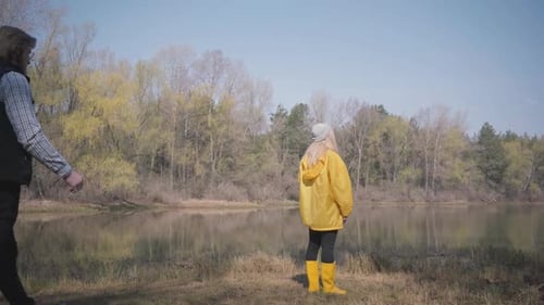 Young Blond Woman Standing Looking at Amazing View of River and Forest and Bearded Handsome Man Come
