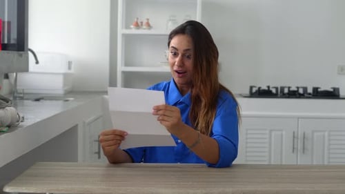Woman Reads Letter, Reacts with Joy and Excitement