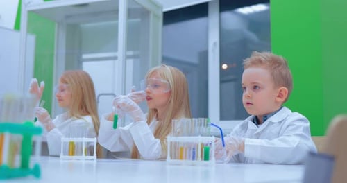 Children Conduct Science Experiments in a Bright Laboratory