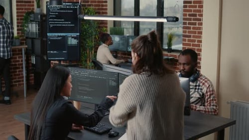 Software Programer Pointing Pencil at Source Code on Computer Screen Explaining Algorithm to
