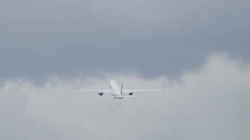 generic widebody commercial passenger airplane taking off departing airport from a city.