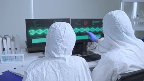 Scientists in Protective Suits Reviewing DNA Research